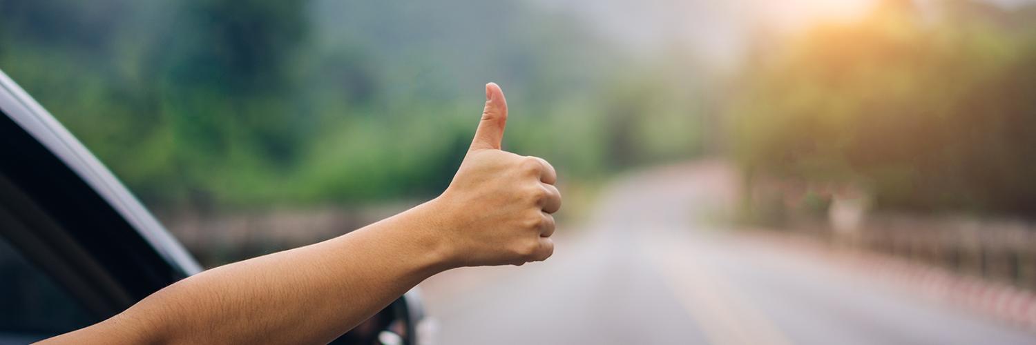 Thumbs up from car window
